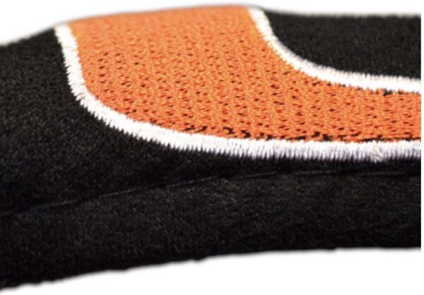 Close-up of a black fabric texture with a partially visible embroidered Miami Hurricanes Steering Wheel Cover logo.