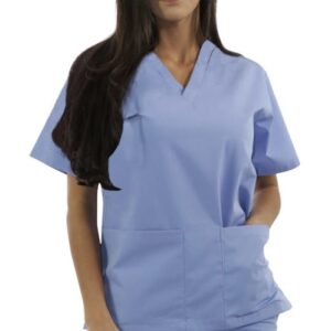 A woman in blue scrubs stands with her hands in her pockets against a white background.