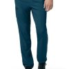 Person wearing blue CARHARTT C55106 - MEN'S ATHLETIC CARGO PANT and black sneakers, focusing on the lower half of the body.