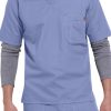 A man wearing a SOLID RIPSTOP SCRUB UTILITY TOP (Men's C15108) with a chest pocket and grey long-sleeve undershirt.