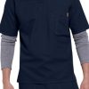 Man in SOLID RIPSTOP SCRUB UTILITY TOP (Men's C15108) medical scrubs with layered gray undershirt, standing with hands partly visible.