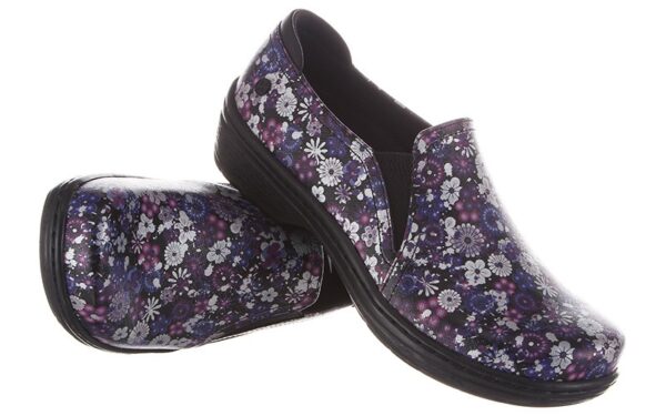 A pair of Moxy by Klogs Footwear slip-on shoes with a black sole on a white background.