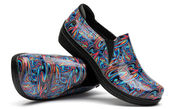 A pair of Moxy by Klogs Footwear slip-on shoes with a vibrant, multicolored psychedelic swirl pattern, set against a white background.