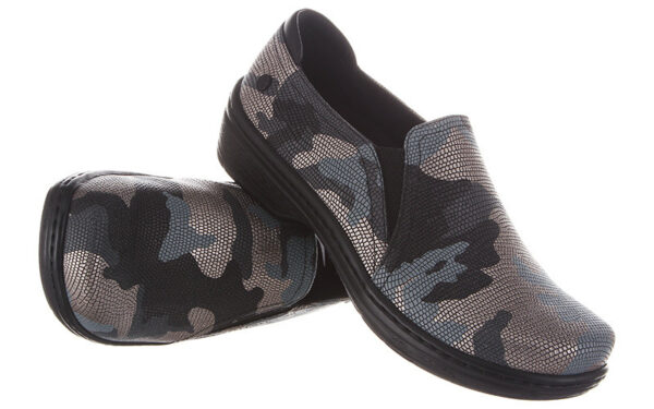 A pair of Moxy by Klogs Footwear slip-on shoes with a camouflage pattern, displayed against a white background.