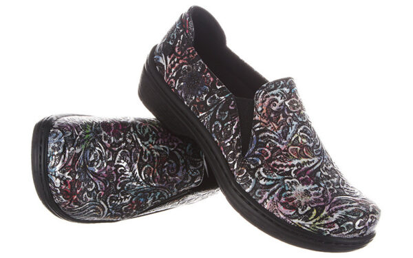 A pair of Moxy by Klogs Footwear slip-on shoes with dark background and multicolored print, displayed against a white backdrop.
