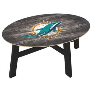 Oval wooden coffee table with a distressed finish featuring the Miami Dolphins Football and My Dog Sign in the center, supported by black legs.