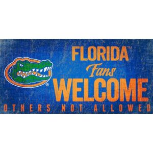 University of Florida Fans Welcome Sign featuring the text "florida fans welcome others not allowed" with an image of a gator and the trademark symbol, styled in blue and orange.