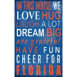 Decorative vertical University of Florida In This House sign with text "in this house we love hug laugh a lot dream big are grateful have fun cheer for florida" in white on a blue background.