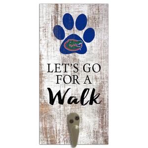 Decorative door sign featuring a blue dog paw print with a Florida Gators logo, the phrase "let's go for a walk," and a hook for leashes on a rustic wood background.