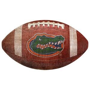 A University of Florida 12" Football Shaped Sign with the Florida Gators logo, featuring a detailed alligator graphic on a textured brown surface.