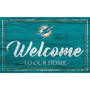 A weathered teal wooden sign with the Miami Dolphins Football and My Dog Sign logo and white text saying "welcome to our home.