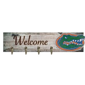 A University of Florida Coat Hanger 6x24 featuring a colorful alligator illustration and three metal hooks, attached to a weathered wood background.