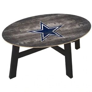 Oval wooden coffee table with a dark star design on a distressed gray background, supported by black legs.