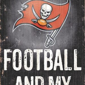 Sign with the text "all i need is football and my dog" featuring a tampa bay buccaneers logo, displayed on a worn, wooden background.