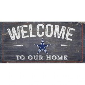 Vintage "welcome to our home" sign with a star in the center, displayed on a distressed wooden background.