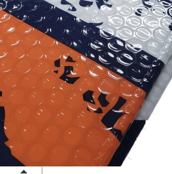 A stack of colorful Miami Hurricanes Auto Shades with bubble wrap interiors, featuring navy blue, white, and orange colors with a visible black logo on the navy shade.