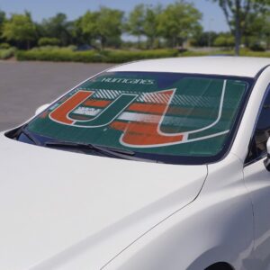 Rear windshield of a white car featuring a large Miami Hurricanes Auto Shade sunshade in a parking lot.