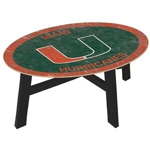 Oval-shaped coffee table with a distressed green and orange top featuring the miami hurricanes logo, mounted on black metal legs.