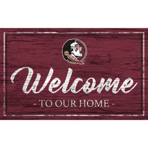 Rectangular welcome sign featuring "welcome to our home" in white cursive on a burgundy background, with a florida state university seminoles logo on the left.