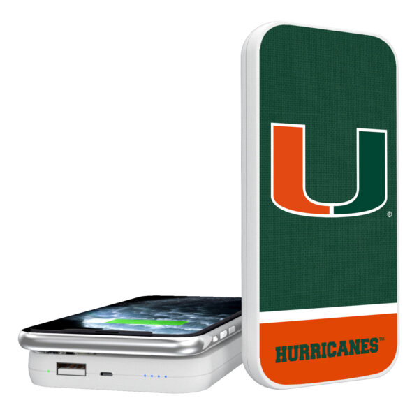 Miami Hurricanes Solid Wordmark 5000mAh Portable Wireless Charger with a university of miami hurricanes logo connected to a smartphone, indicating charging status with blue led lights.