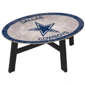 Oval-shaped table with the dallas cowboys logo on the top, featuring a distressed white and blue design, supported by black legs.