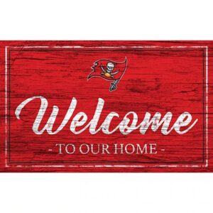 Red wooden welcome sign with the text "welcome to our home" and a pirate skull emblem on the top left corner.