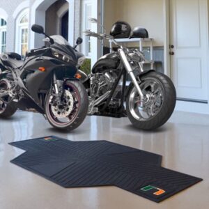 Two University of Miami Hurricanes Motorcycle Mats parked in a garage with protective mats on the floor.