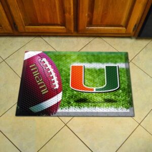 A University of Miami Hurricanes Scraper Mat featuring a football and the letter "u" logo on a green grassy background, placed on a tiled floor in front of a wooden door.