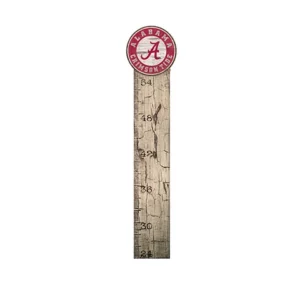 A wooden growth chart with a distressed finish, featuring a white scale in inches and topped with a circular university of alabama logo.