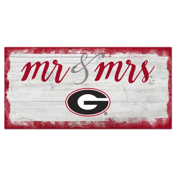 A red and white sign with "mr & mrs" written in cursive and the georgia bulldogs logo on a weathered wooden background.