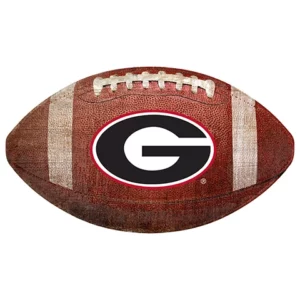 An american football with the university of georgia "g" logo in black and white centered on its side.