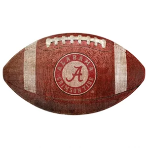 A vintage american football with an "alabama crimson tide" logo emblazoned on it.