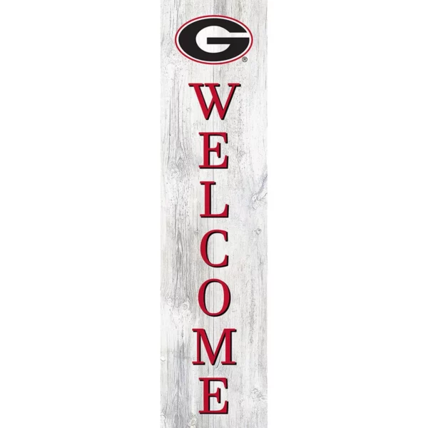 A vertical welcome sign featuring red letters on a distressed white wooden plank, with the letter "o" replaced by the university of georgia "g" logo.