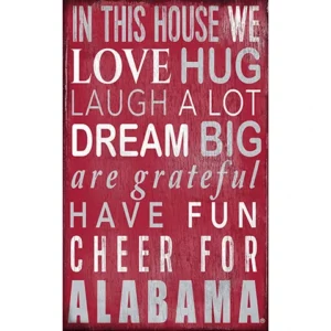 Decorative sign with text "in this house we love, hug, laugh a lot, dream big, are grateful, have fun, cheer for alabama" on a red background.