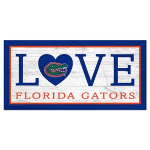 Decorative sign featuring the words "love florida gators" with the "o" replaced by the University of Florida Love 6x12 Sign logo, framed in blue on a distressed white and red background.