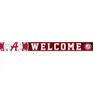 Decorative sign featuring the word "welcome" in white capital letters set on a red distress-textured background, with the logo of the university of alabama on the right.