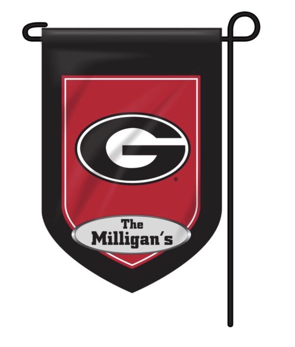 A red and black Personalized Collegiate Garden Flag featuring a large white "g" inside a black circle, with the text "the milligan's" below it, hanging from a horizontal pole.